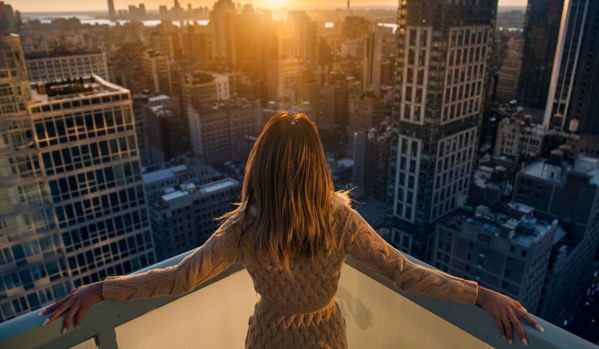 Rich,Woman,Enjoying,The,Sunset,Standing,On,The,Balcony,At